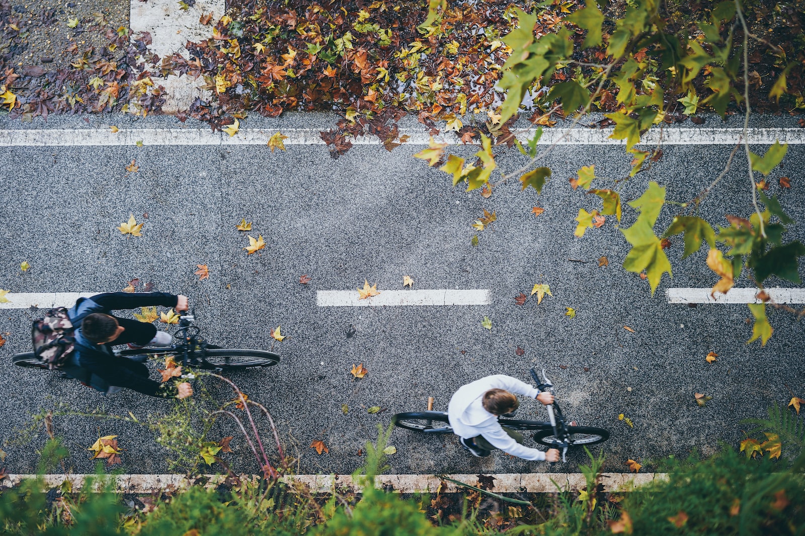 aerial photography of man riding bike on streets