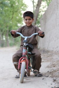 a boy sitting on a bicycle